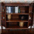 F06. Bookshelf with inlaid band on top. 35”h x 43”w x 11”d 